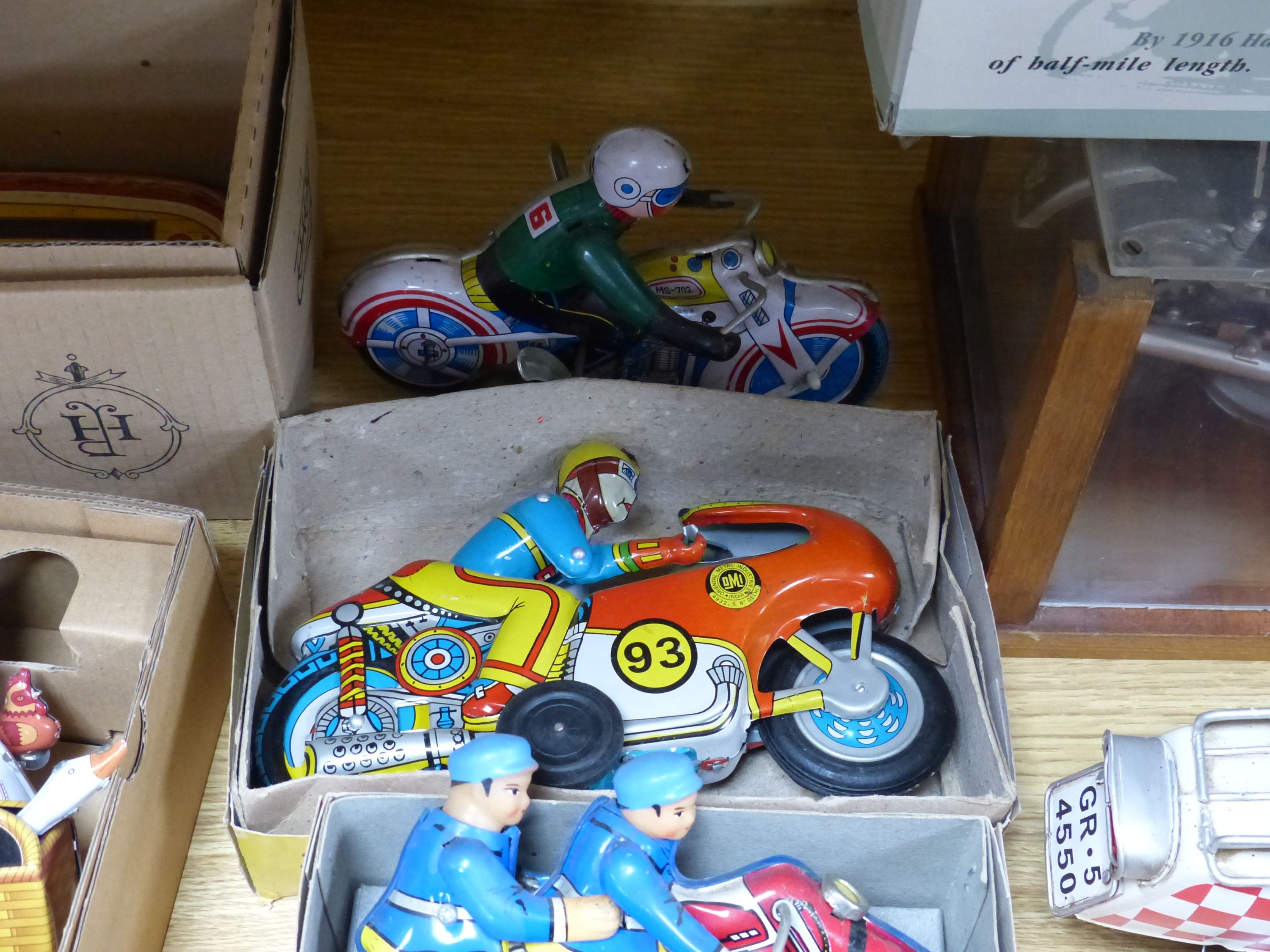 A collection of tinplate motorcycles etc